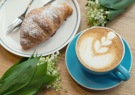 Coffee and croissant on the rustic background. Concept and idea