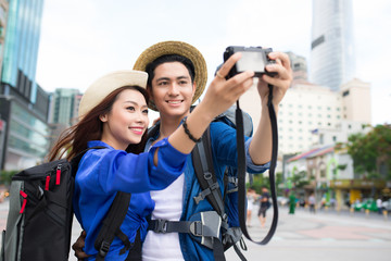 Happy tourists taking photo of themselves. summer holidays, travel, vacation, tourism and dating...