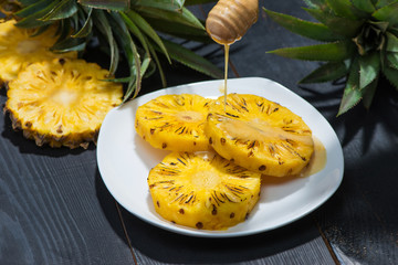 Grilled pineapple on a black wooden table