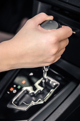 Hand shifting the gear of the car