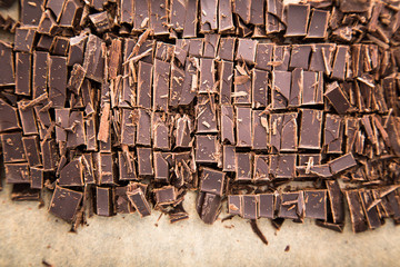 Stack of chocolate slices with mint leaf. dark chocolate over wooden background, selective focus