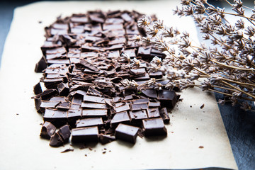 Stack of chocolate slices with mint leaf. dark chocolate over wooden background, selective focus