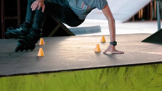 Rollerblader in slow motion. Slalom cones and inline skater. Improve your balance.
