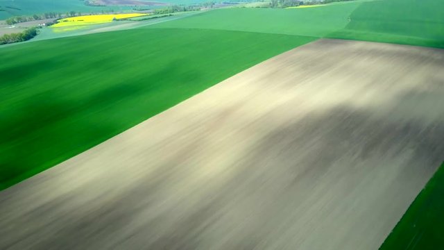 Aerial view of agricultural landscape. Scenic footage of rural land in a spring time.