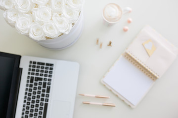 Diary with blank paper, flower bouqet and laptop, coffee on white table