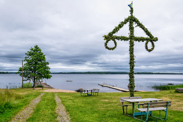 Midsummer maypole on the lake coast