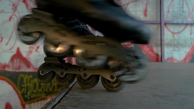 Inline skates in slow motion. Rollerblades and ramp.