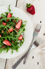 Fresh salad with arugula and strawberries