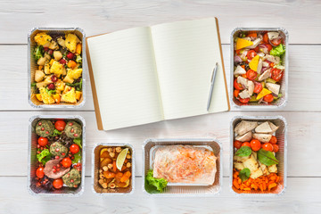 Healthy food take away in boxes, top view at wood