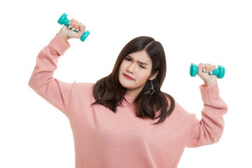Exhausted Asian woman with dumbbells.
