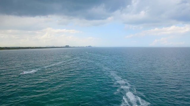 Cool Aerial shot of ocean with jet skis riding  