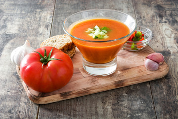 Traditional Spanish cold gazpacho soup on wooden table
