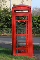 Vertical shot of an old British red telephone box