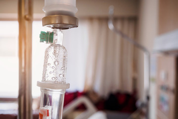 Medical drip with hospital blurred background