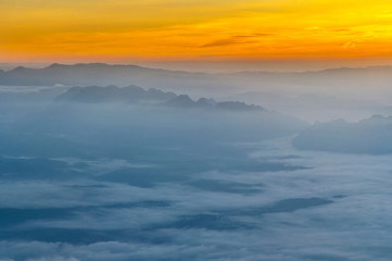 Fototapeta na wymiar Mountain layer with fog and cloud at dawn