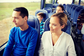 happy couple or passengers in travel bus