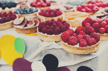 Fruit and berry tarts dessert tray assorted outdoors