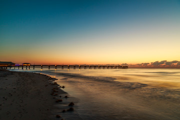 Beautiful dawn and silky water at fishing pier at Dania beach, FL 