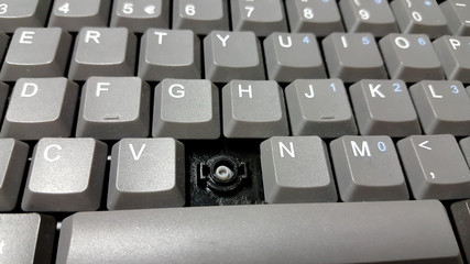 Closeup of and old and dirty laptop keyboard missing a key