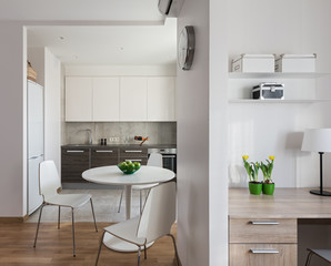Interior of modern apartment in scandinavian style with kitchen and workplace.