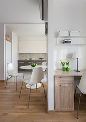 Interior of modern apartment in scandinavian style with kitchen and workplace.