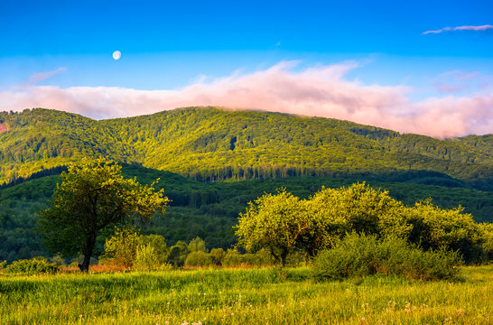 moonrise over the mountain in rural area at sunset
