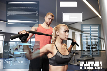 man and woman flexing muscles on gym machine