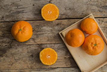 Fresh half cut oranges on wooden table