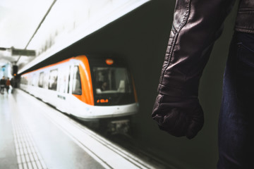 Violence in public transportation. Threatening dangerous man standing in underground subway...