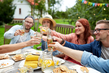 happy friends with drinks at summer garden party