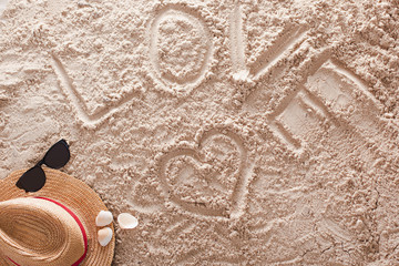 Fototapeta na wymiar Love written in a sandy tropical beach