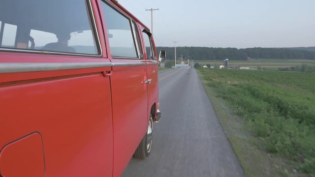 Red Van Driving on Country Road