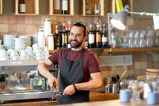 barista with holder and tamper making at coffee