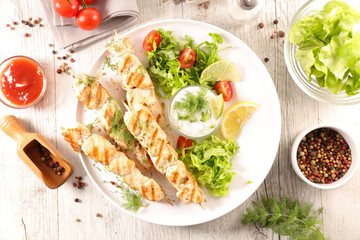 grilled chicken skewer and salad