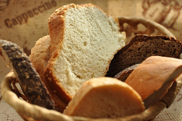 Assorted sliced bread in a wicker basket.