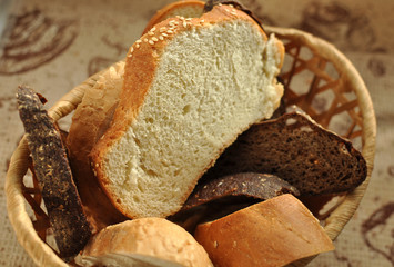 Assorted sliced bread in a wicker basket.