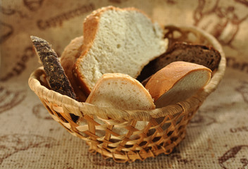 Assorted sliced bread in a wicker basket.