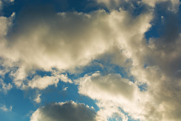 Sky. White clouds illuminated. Grey clouds.