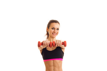 girl stretched forward two hands with pink dumbbells