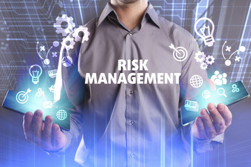 Business, Technology, Internet and network concept. Young businessman working on a virtual screen of the future and sees the inscription: Risk management
