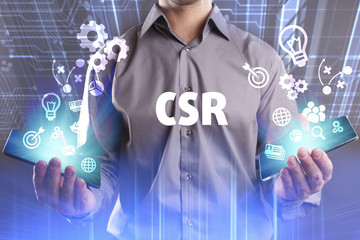 Business, Technology, Internet and network concept. Young businessman working on a virtual screen of the future and sees the inscription: CSR