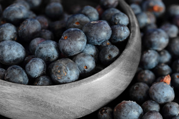 Blueberries in a wooden bowl.  Selective colour