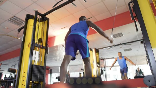 Athlete doing cable flyes on crossover machine for chest and shoulder muscles