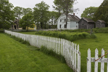 Fototapeta na wymiar Residential houses with white picket fences, Nova Scotia, Canada