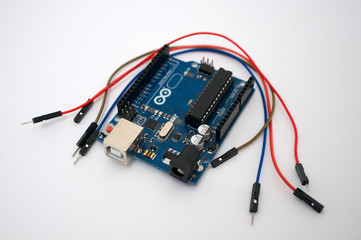 Arduino and around listed wire on a white background
