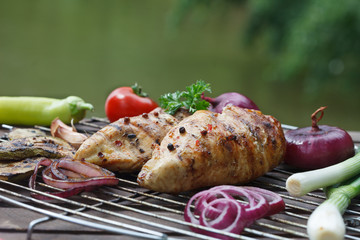 Grilled chicken breast with cherry tomatoe, spring onions, garlic and pepper. Traditional cuisine. 