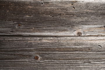 Fototapeta premium Two horizontal weathered timber planks on old wooden building with joint in the middle