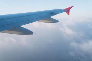 Fototapeta premium Clouds under the wing of an airplane