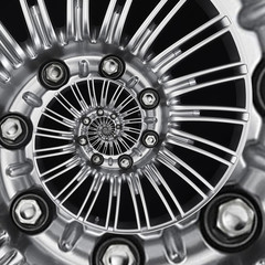 Car automobile wheel rim abstract metallic fractal background. Silver hex nuts, wheel spokes spiral...