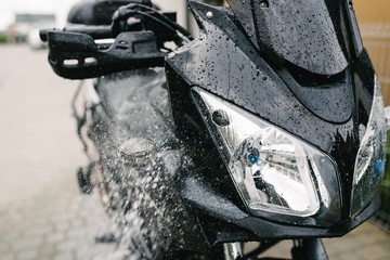Cleaning black touristic motorbike